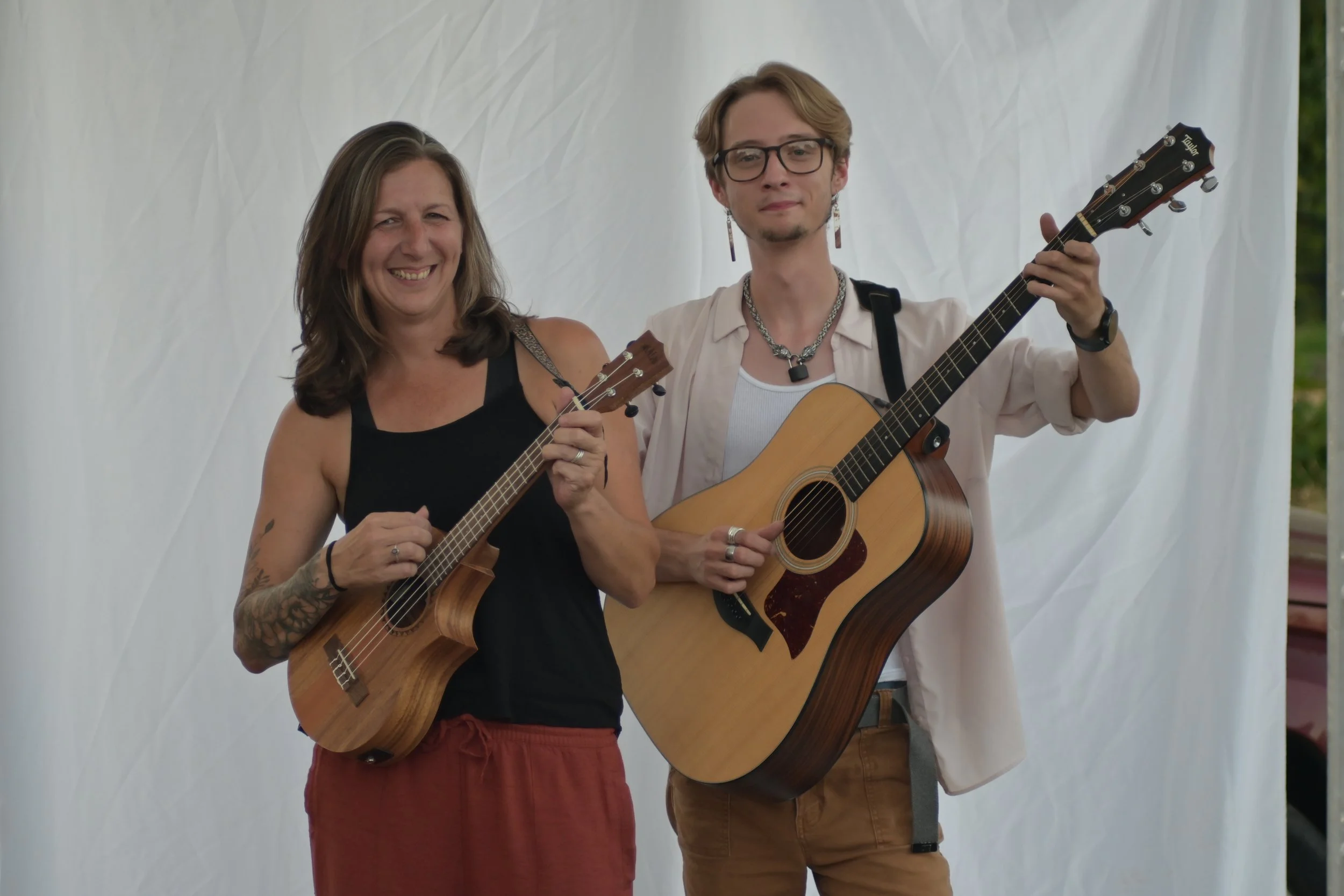 Cooper Morris and Jen Sennett posing with instruments after a performance