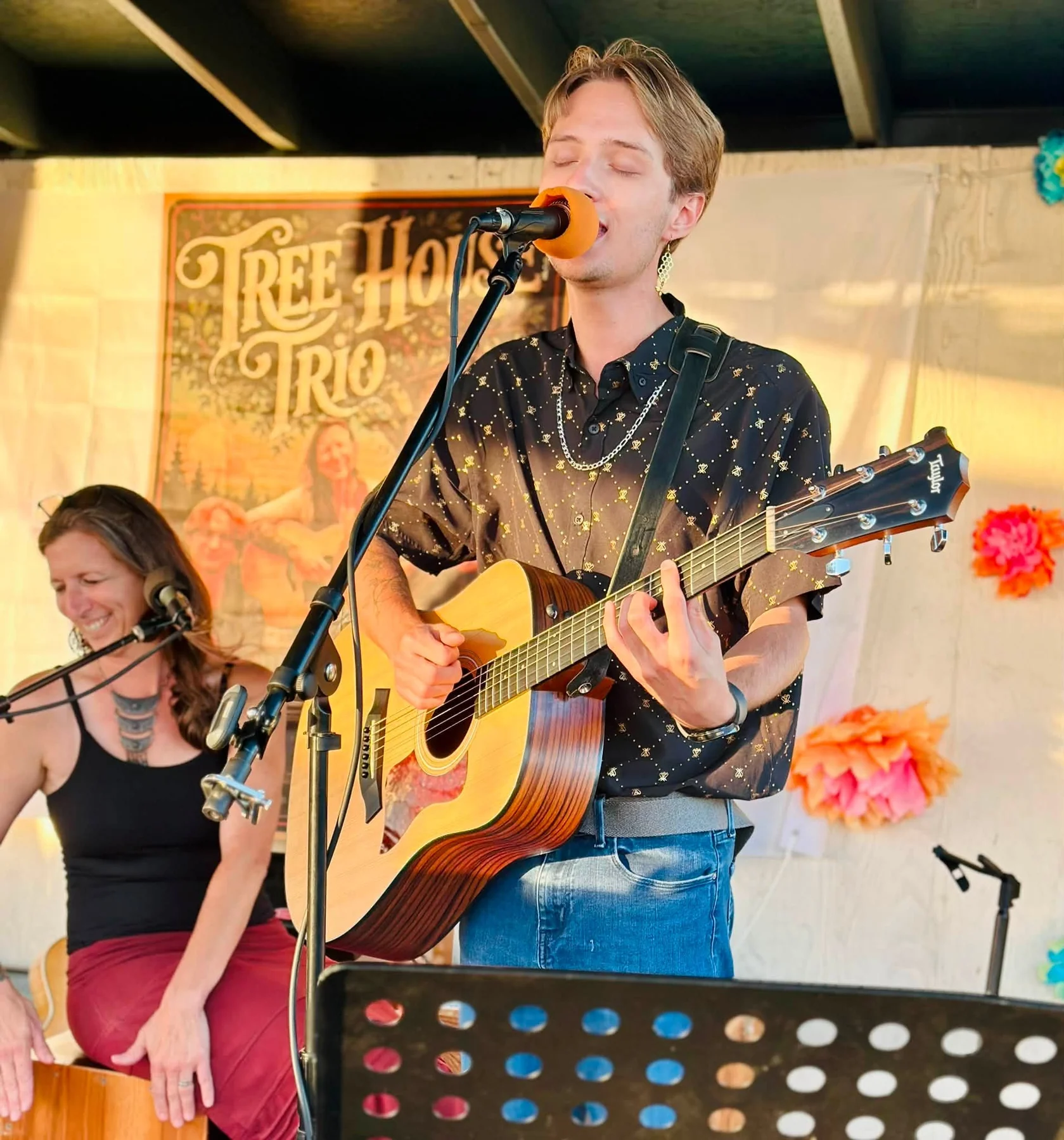 Cooper Morris performing solo with an acoustic guitar during a Tree House Trio set